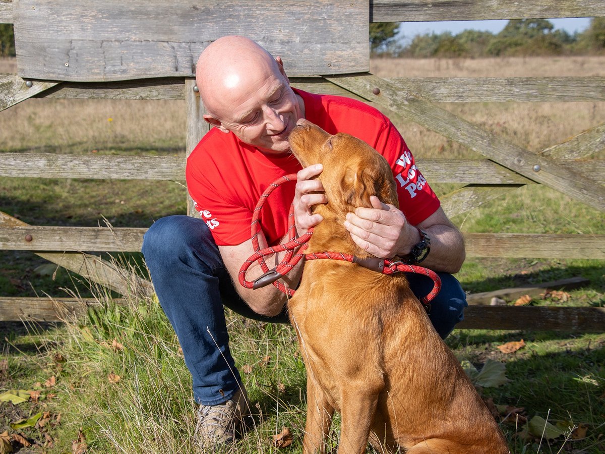 Mark, a We Love Pets franchisee, with a dog in the countryside